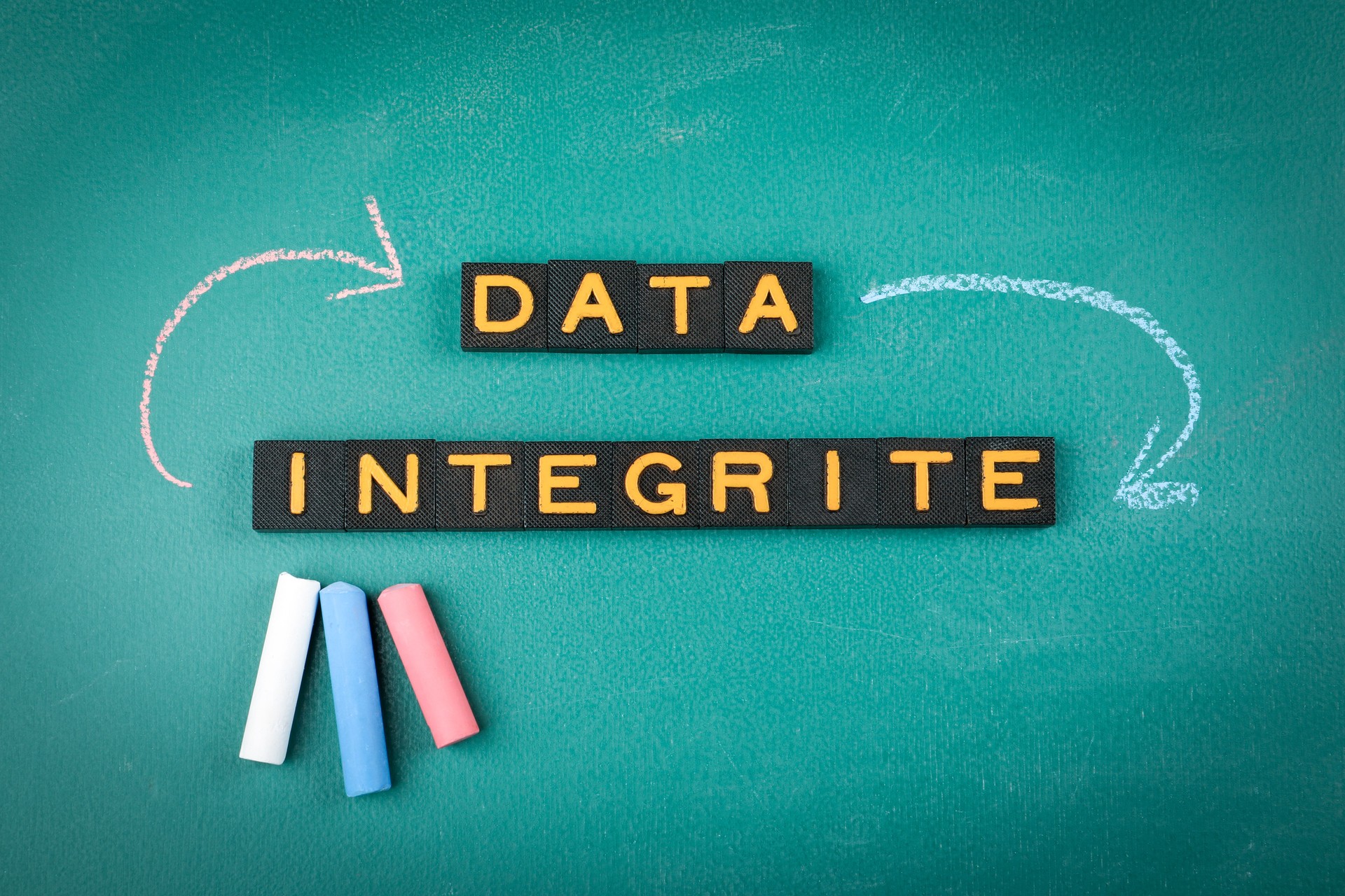 Data Integrity Concept with Arrows and Chalkboard Background
